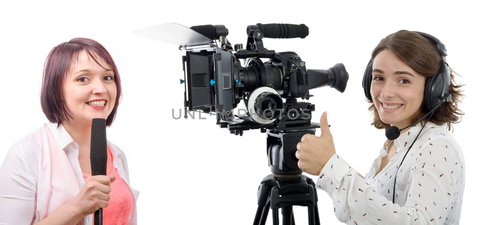 two beautiful reporter women with a camera and microphone