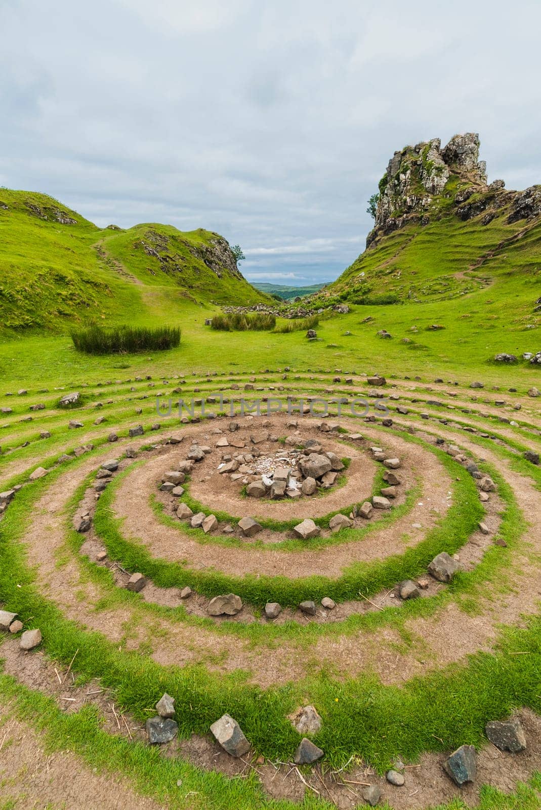 Landscape of a circle of stones and hills with green grass, Fairy Glen, Scotland
