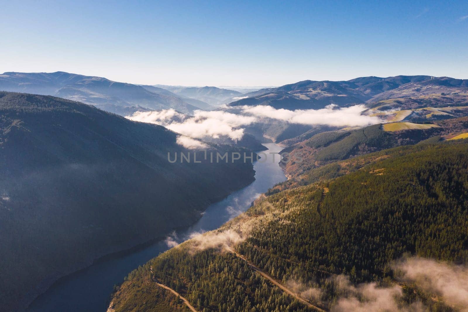 Landscape a river with fog and mountains in a clear day