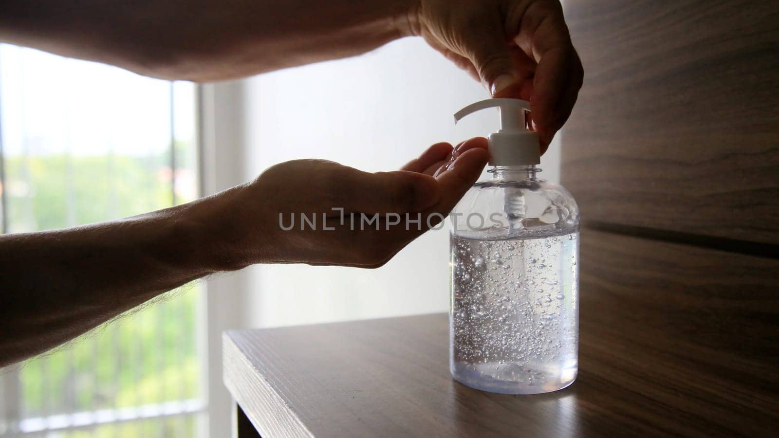 salvador, bahia / brazil - may 12, 2020: person is seen using alcohol gel hand hygiene to protect against Corona Virus.