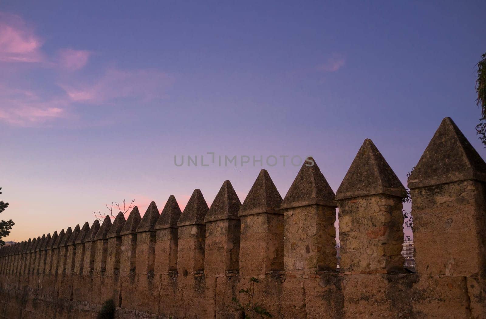 Cordoba muslim city walls battlements at sunset.