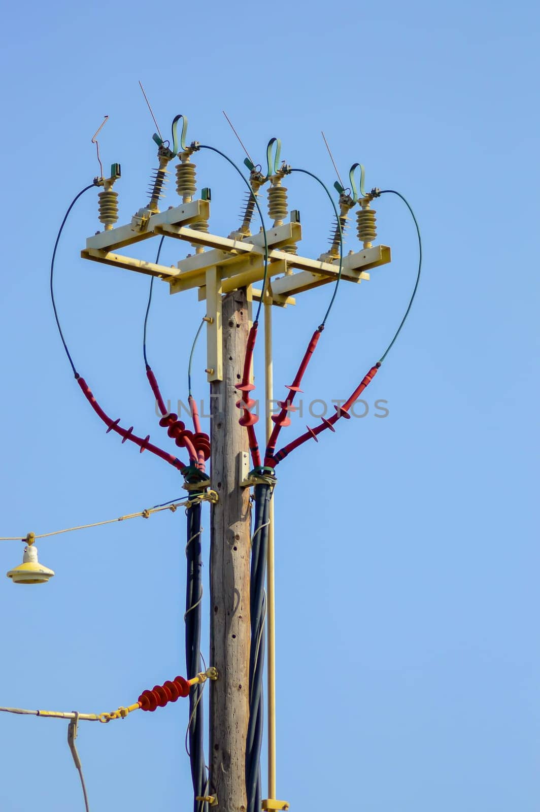 High voltage electric pole and transmission lines with clear blue sky. Electric pylon.