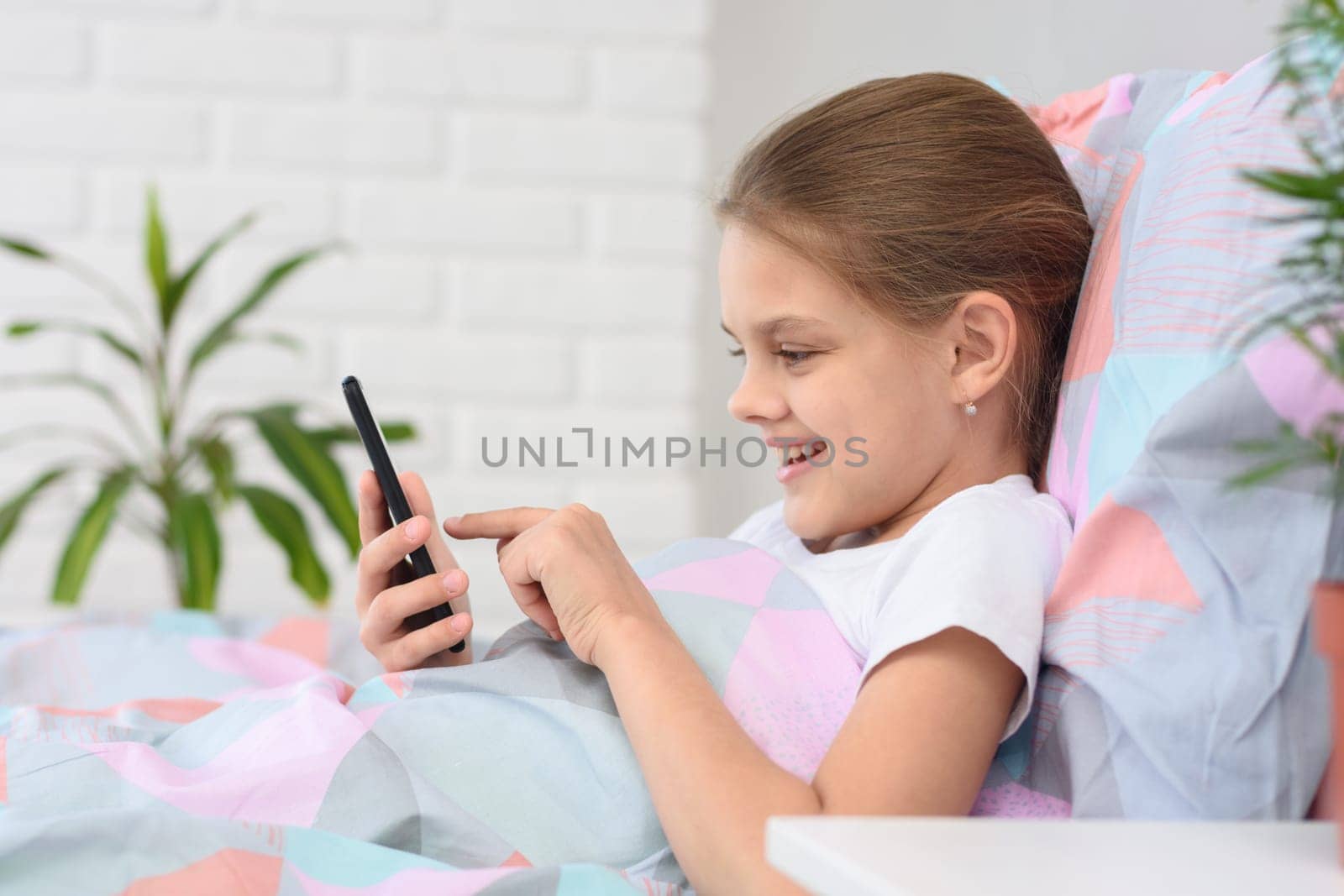 Girl is typing a message in a mobile phone
