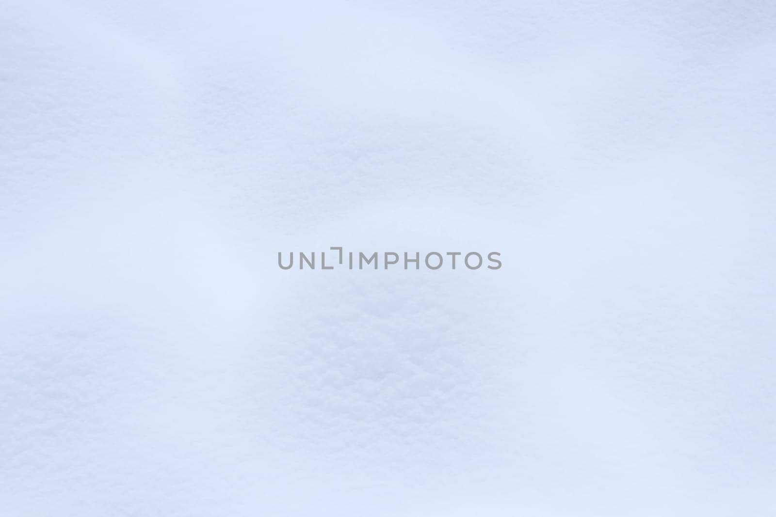 Soft snow hills surface. Snowy mound texture. Winter snowdrift landscape background.