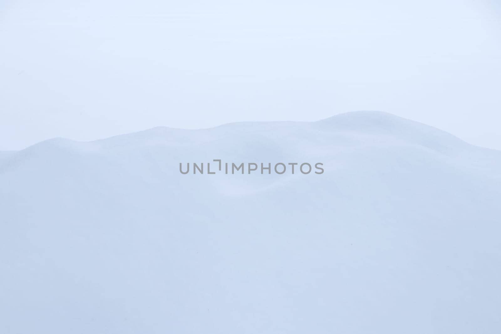 Winter snowdrift landscape background. Soft snow hills surface. Snowy mound texture.