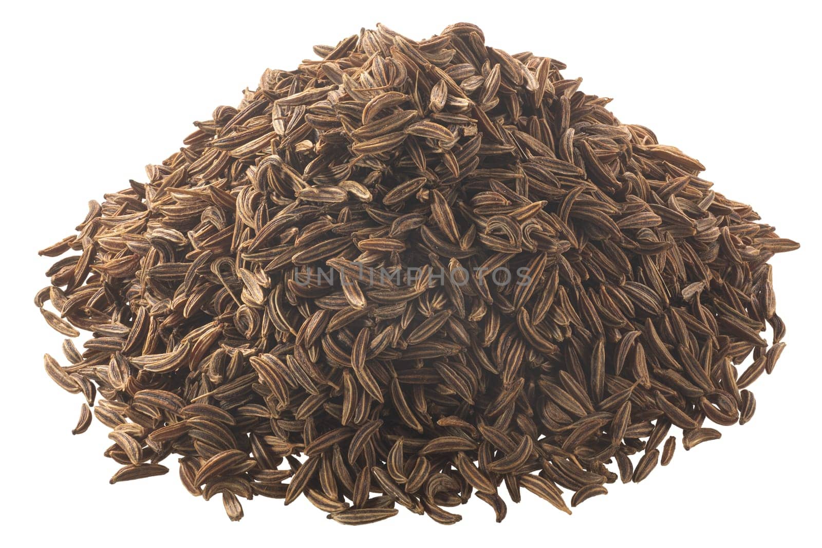 Pile of dried caraway seeds (Carum carvi fruits), isolated