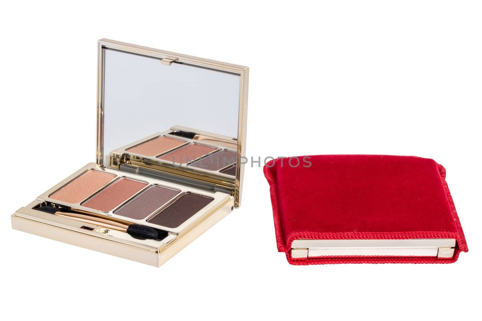 Cosmetic products isolated. Close-up of a elegant cosmetic multi-color box with mirror, eye shadows powder and a eye shadow brush isolated and packed in a red cloth cover on a white background. Macro.