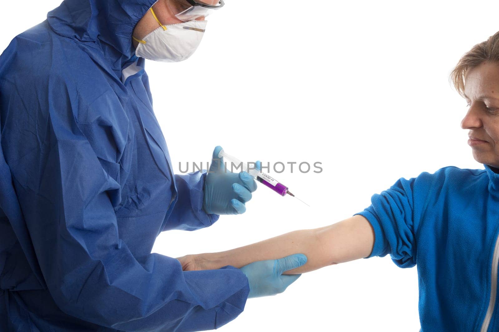 doctor in protective gloves give vacina to women