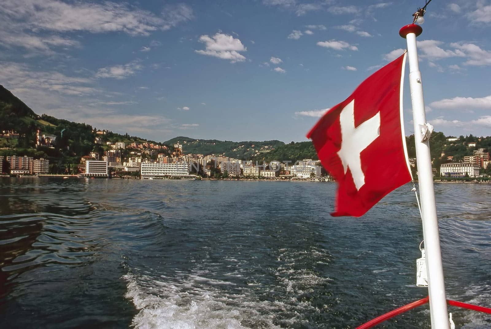 Boat with flag on Lake Lugano, Switzeland