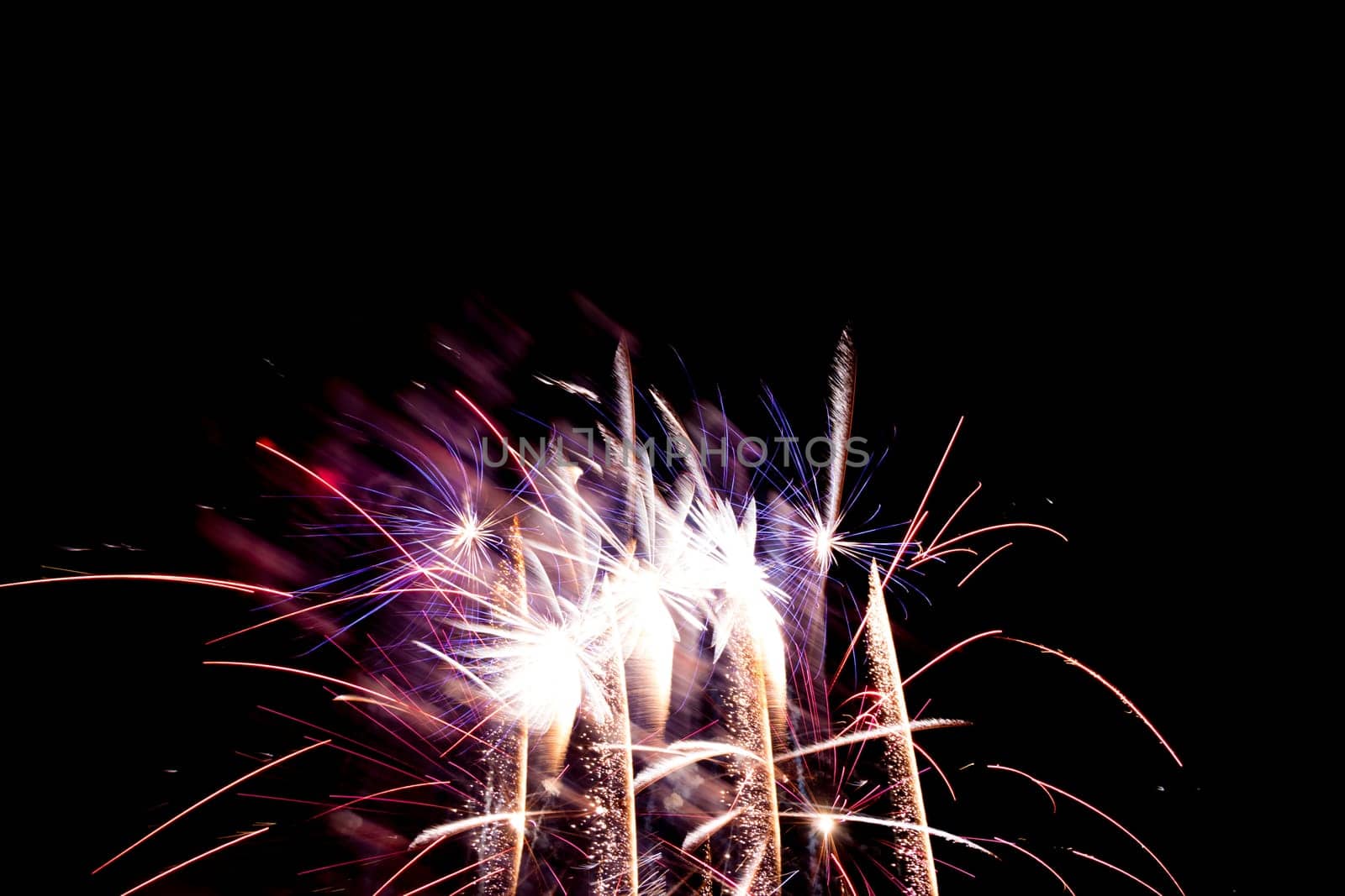 Premium entertainment magic star firework at e.g. New Years Eve or Independence Day party celebration. Black dark night background.