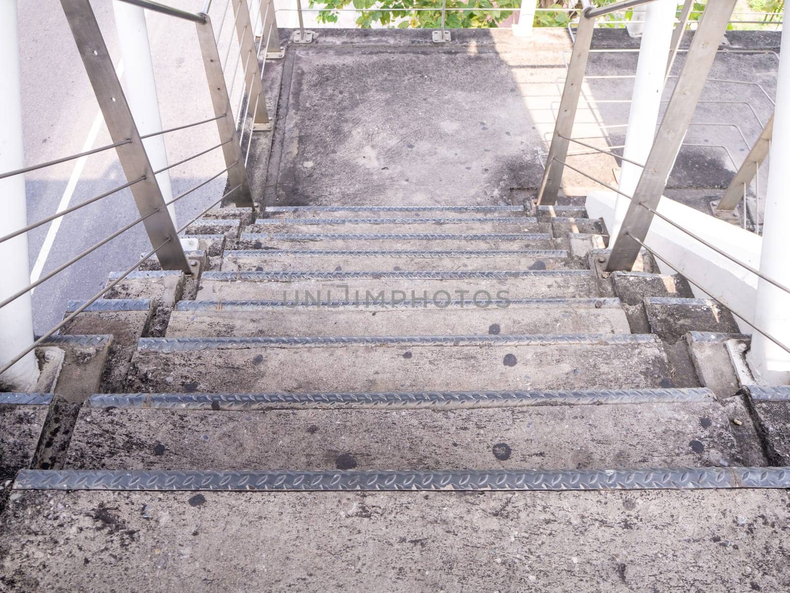 staircase for descending from footbridge. The concrete overpass for crossing the road.