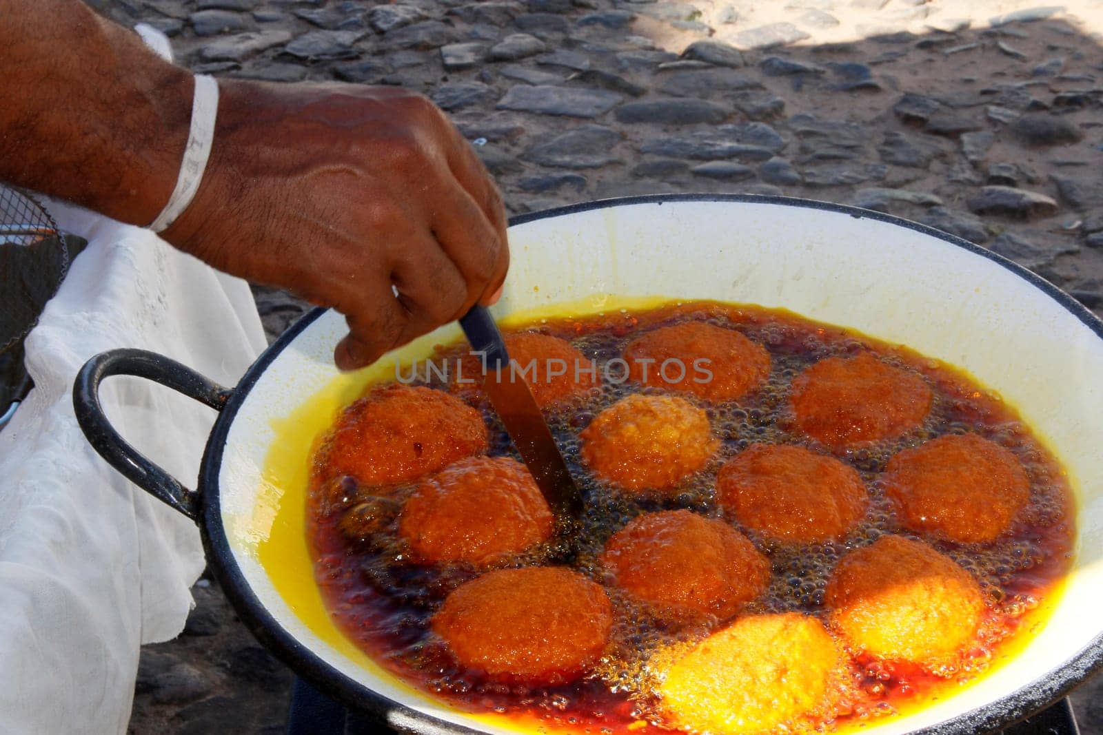 salvador, bahia/ brazil - March 23, 2013: Acaraje is seen during frying in palm oil, in the city of Salvador.