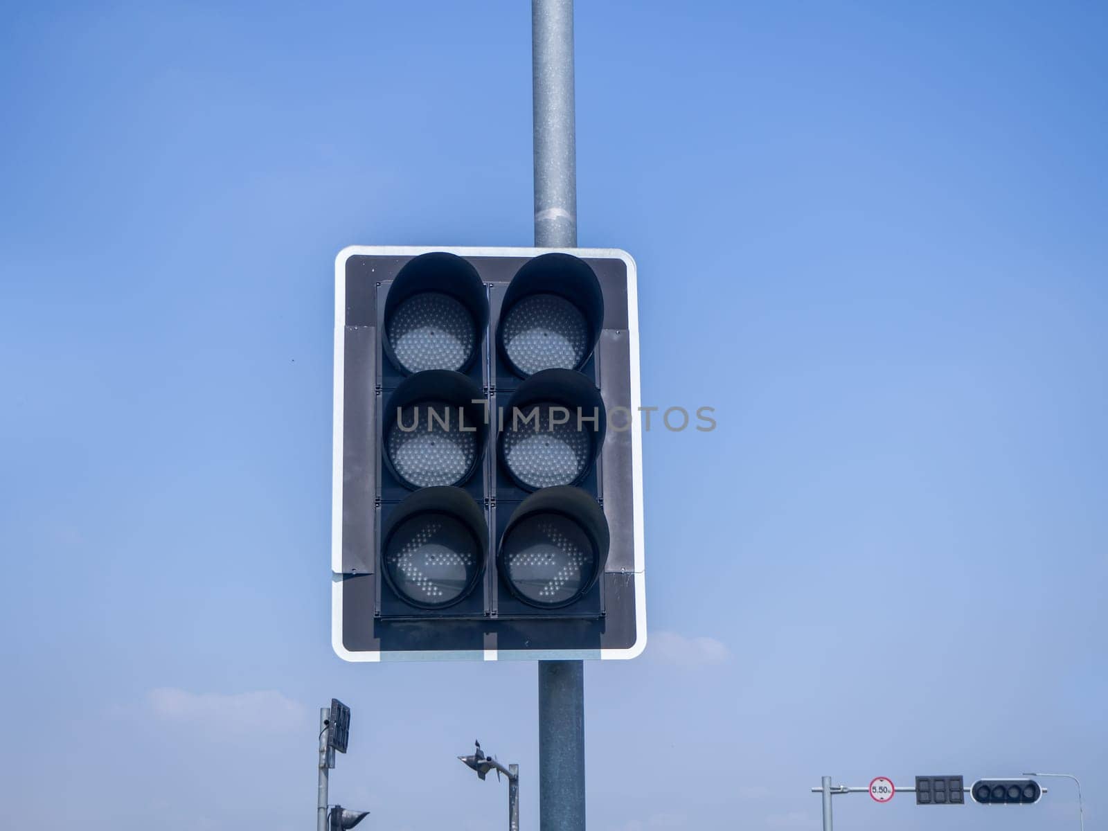 the traffic lights against a vibrant blue sky