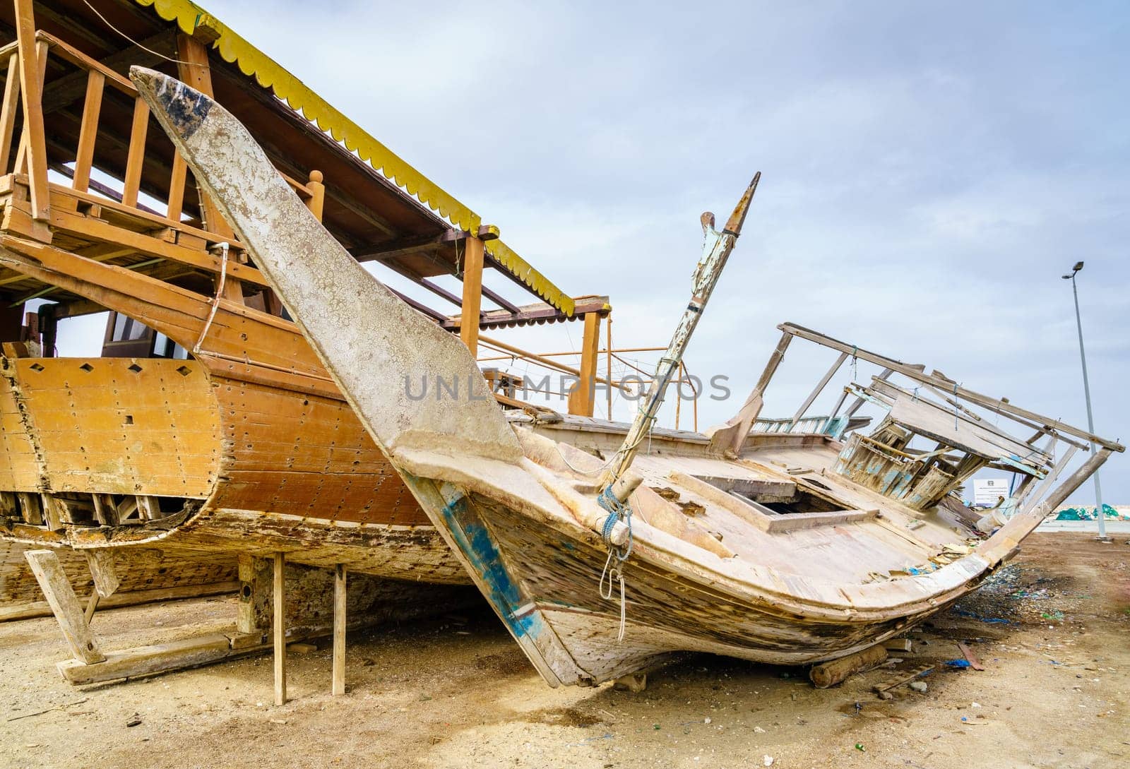 Old destroyed boats on shore near Dibba Port, UAE