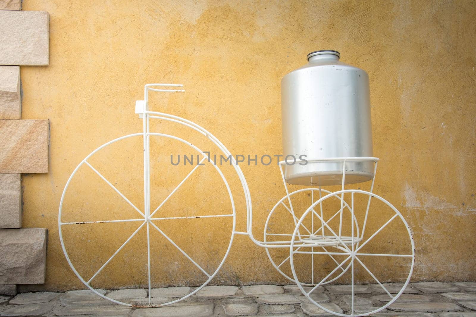light on white decor bicycle on the rock wall background.