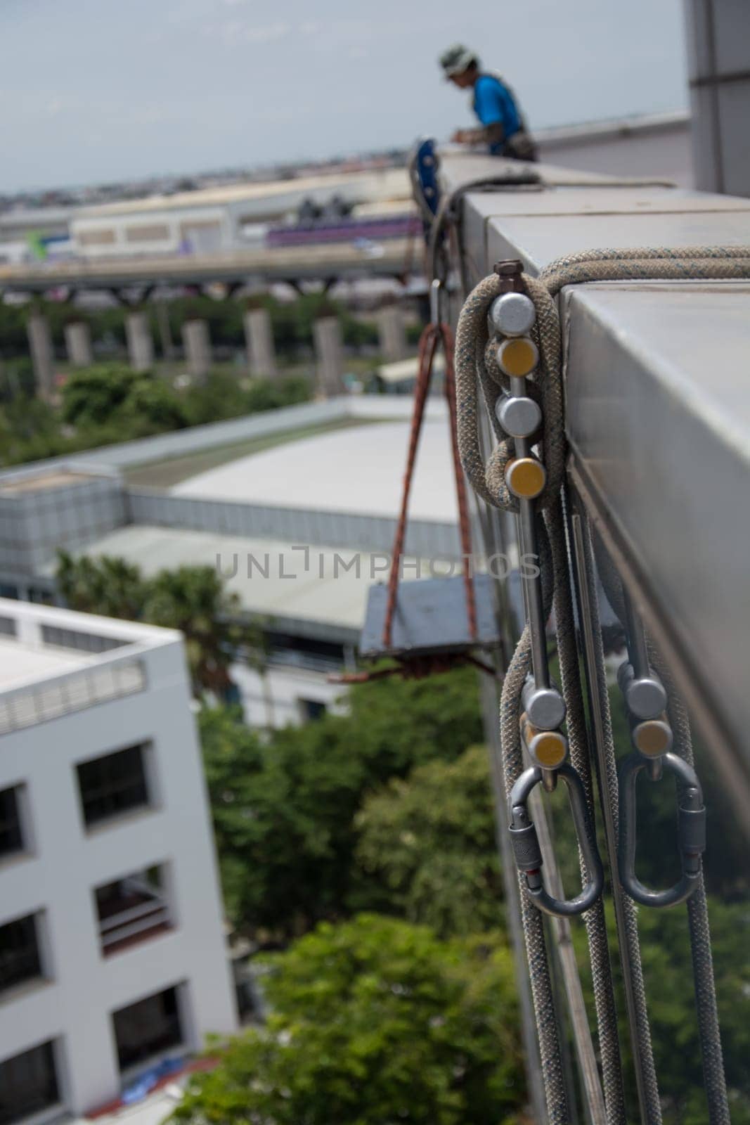 workers cleaning windows service on high rise building