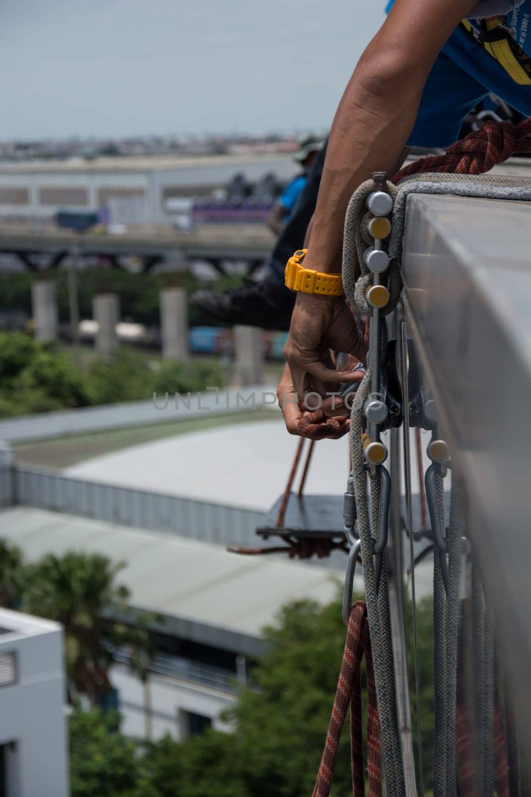 workers cleaning windows service on high rise building