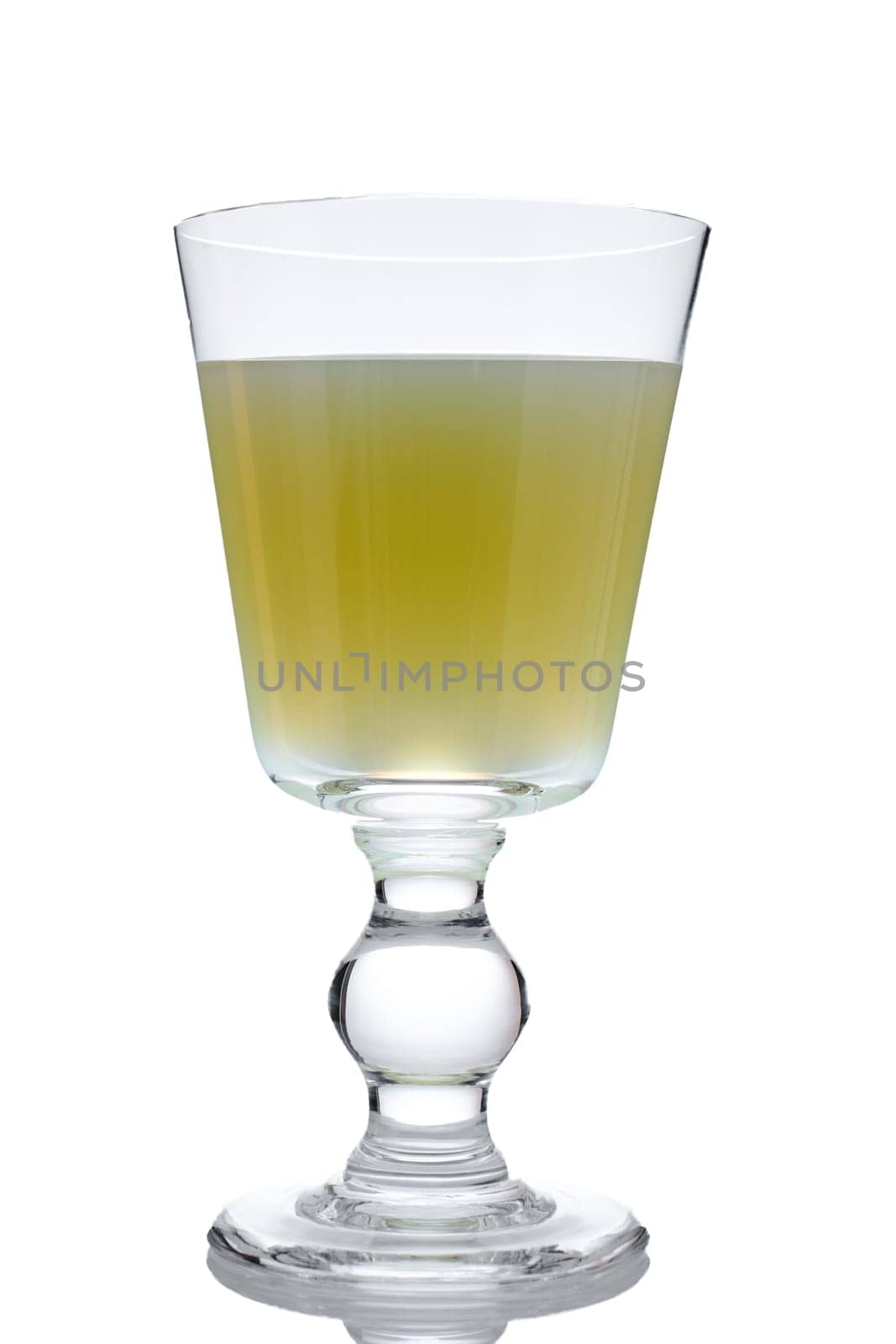 Alcolhol drink jade green absinthe in a glass on white
