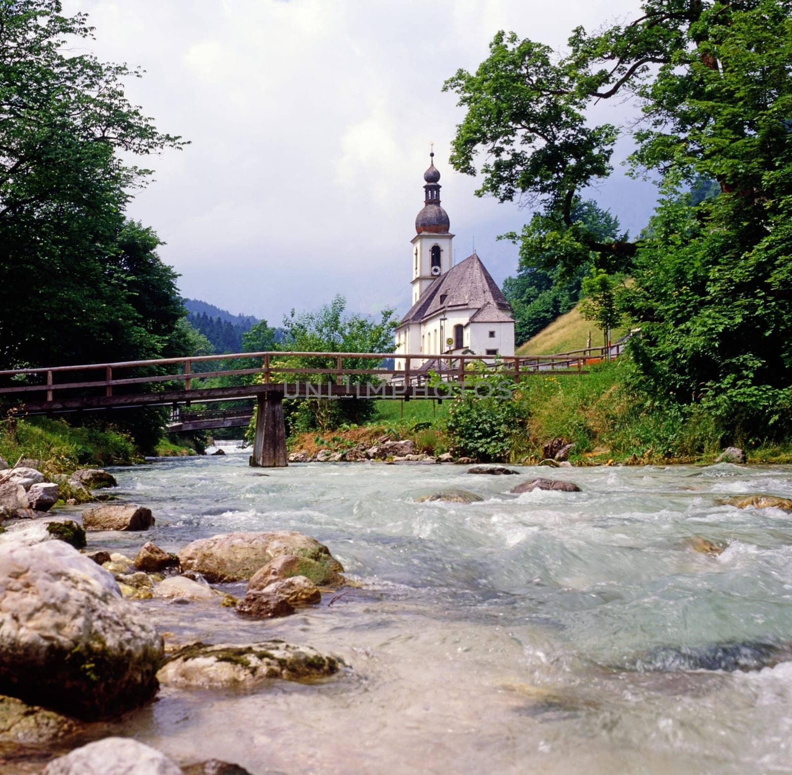 Church with creek and bridge in Ramsau, Germany