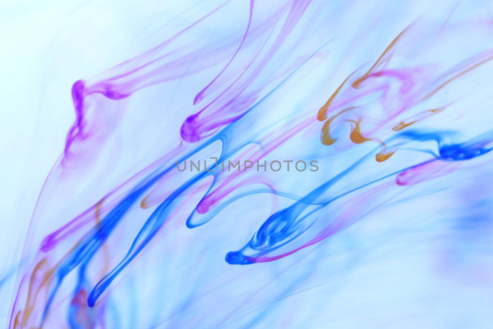 Colored Falling Ink Drops in Water. Abstract Fantasy Background.