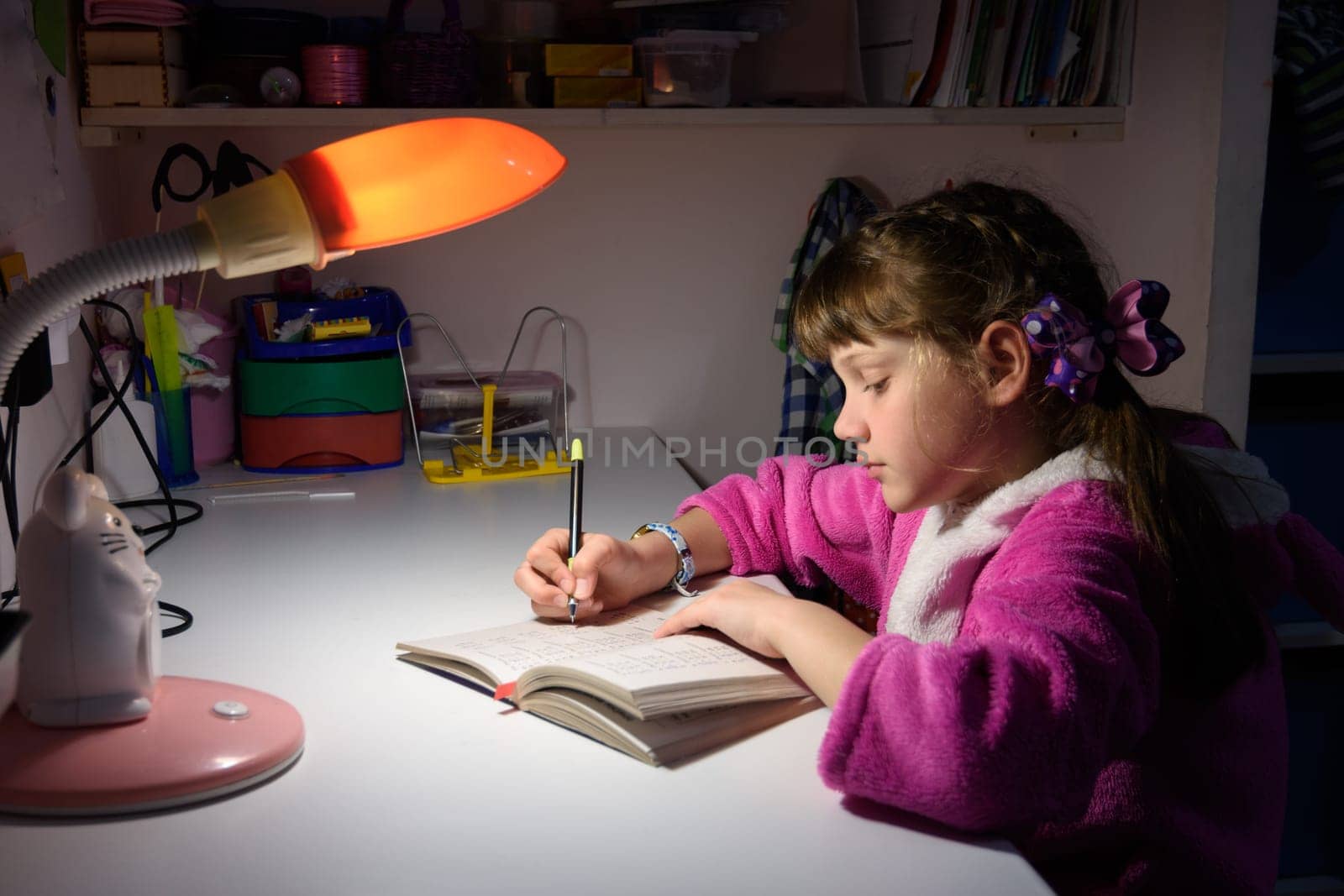 A girl does homework late at night