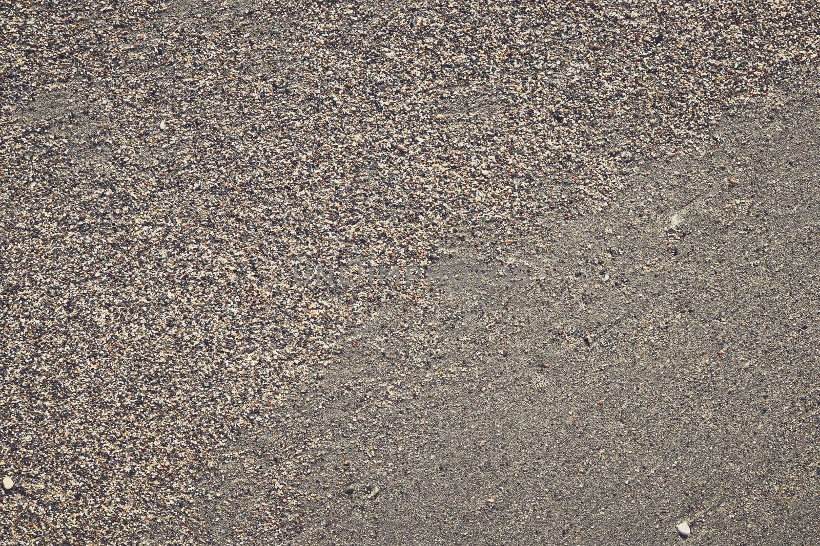 Sand texture with large and small grains transition. Summer beach background.