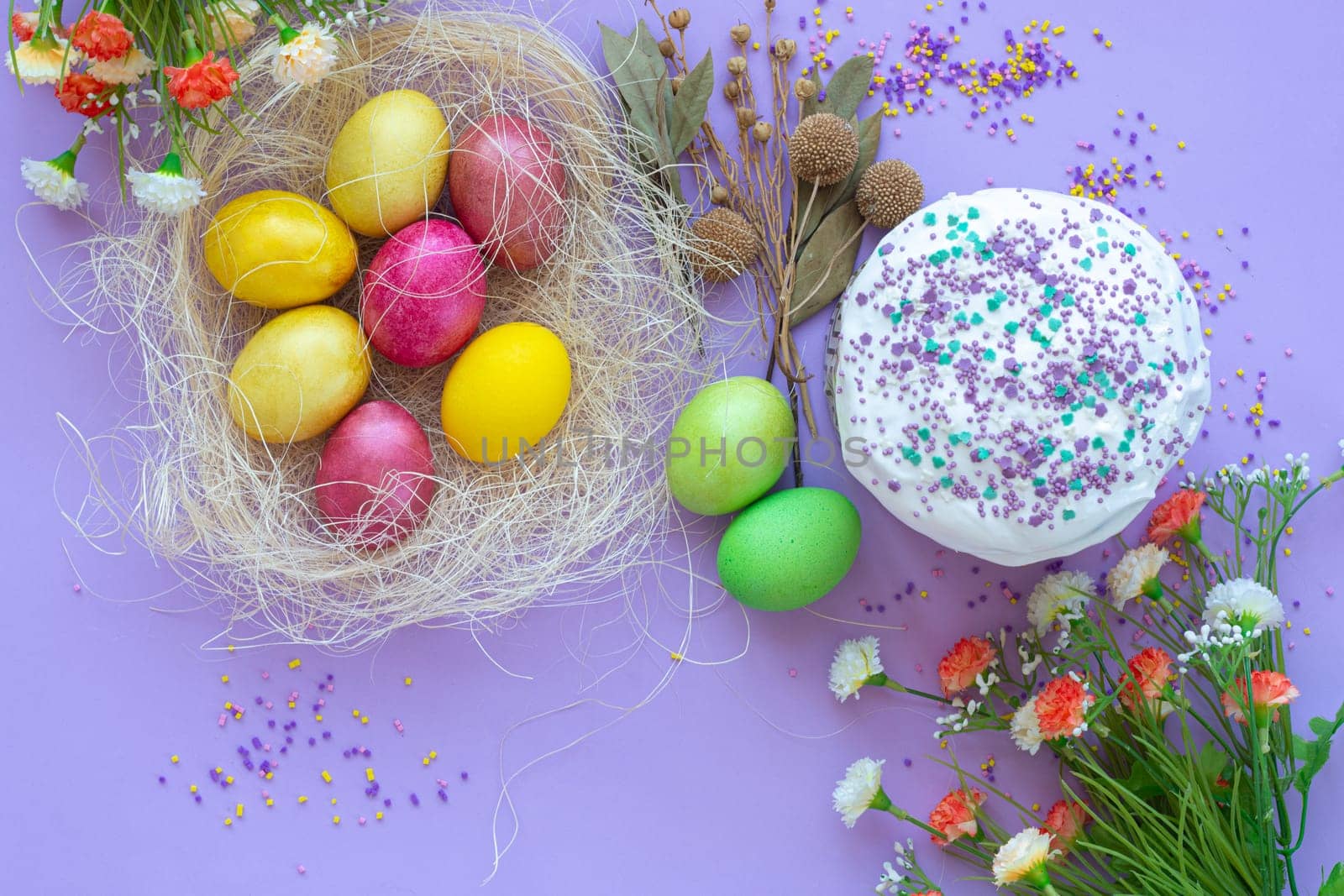 composition of Easter eggs and cake on a purple background