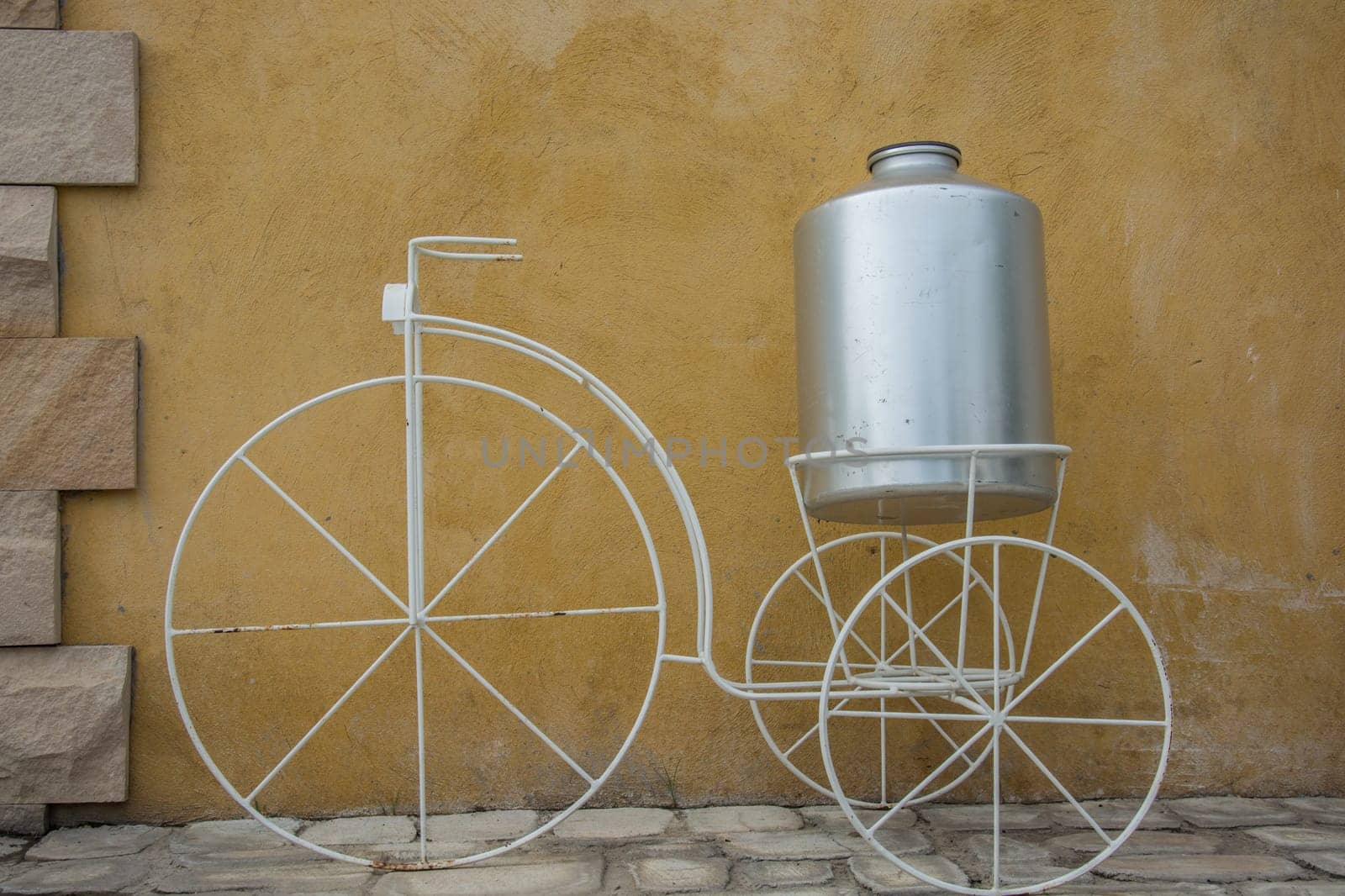 white decor bicycle on the rock wall background.