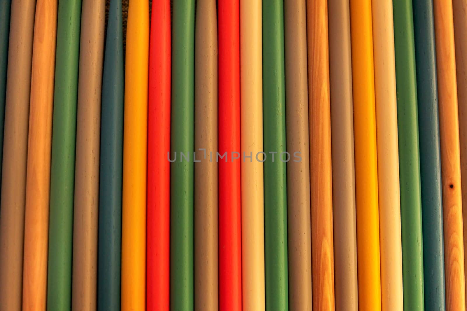 Close up of colored wooden drum sticks arranged in a row