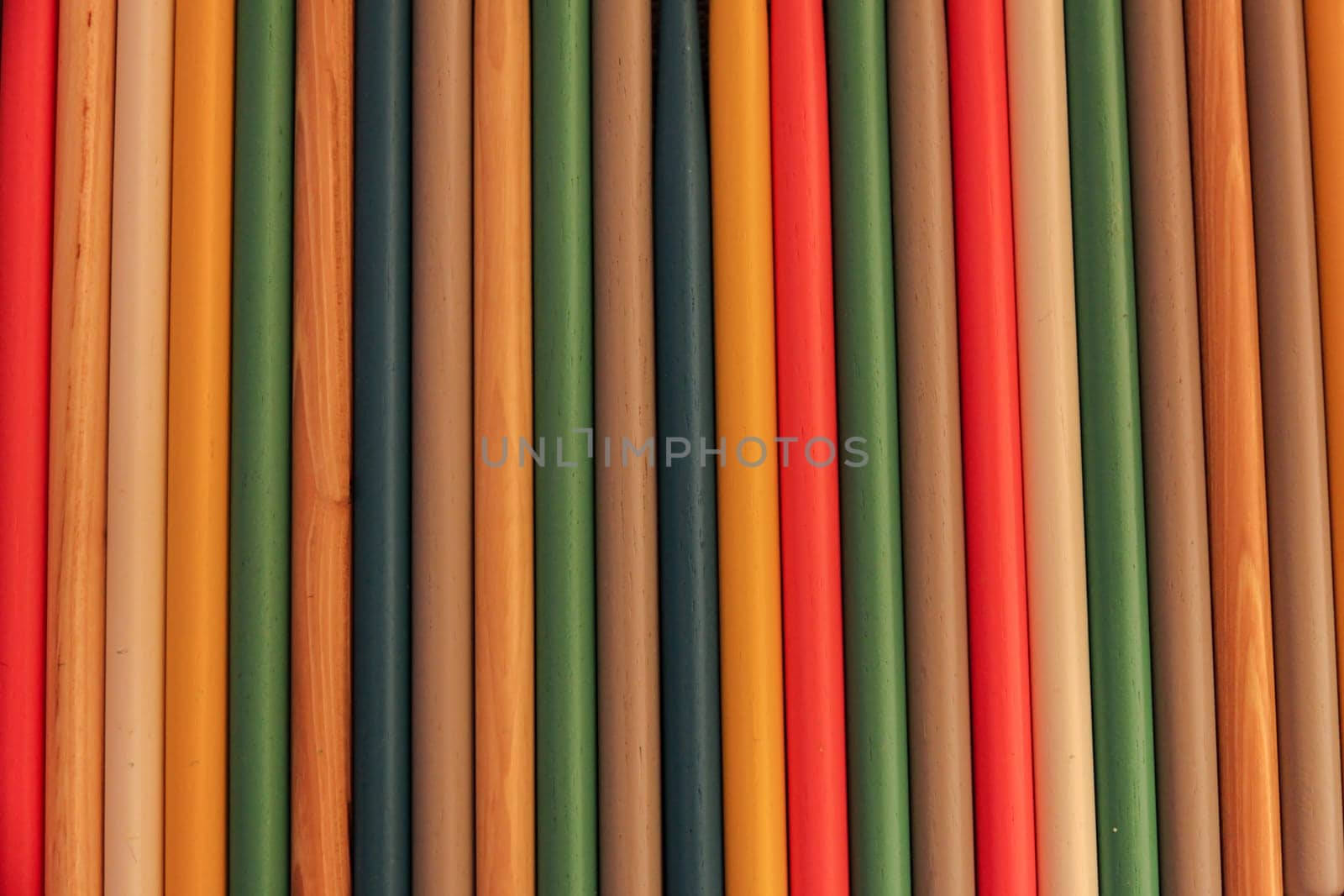 Close up of colored wooden drum sticks arranged in a row