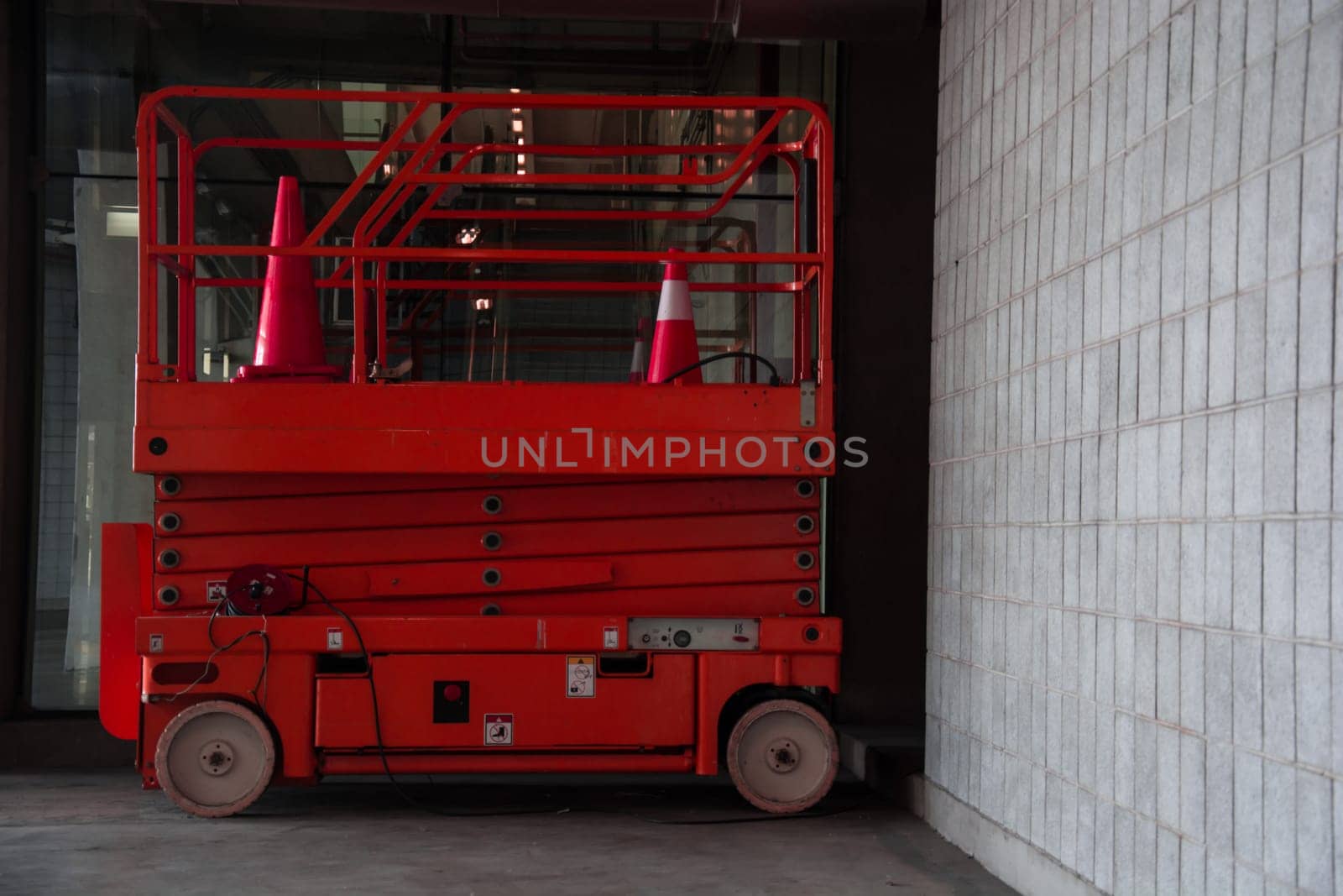 distribution warehouse hall with hydraulic scissors lift platform