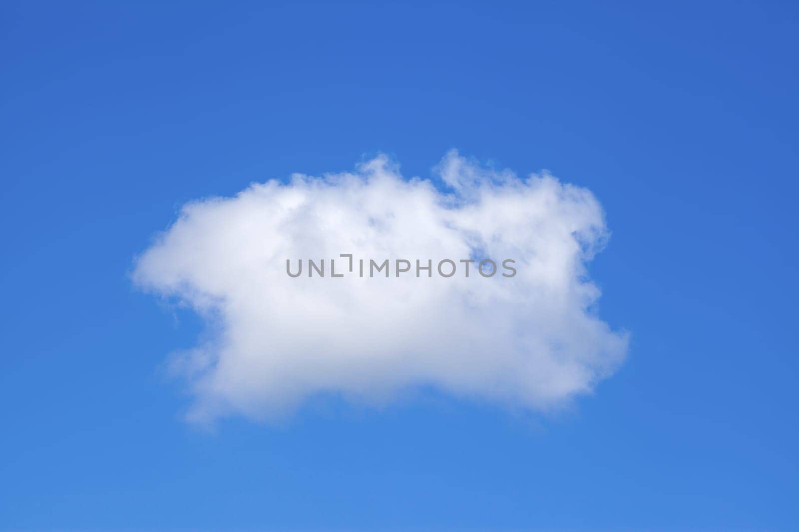 Single white cloud on a blue sky background.