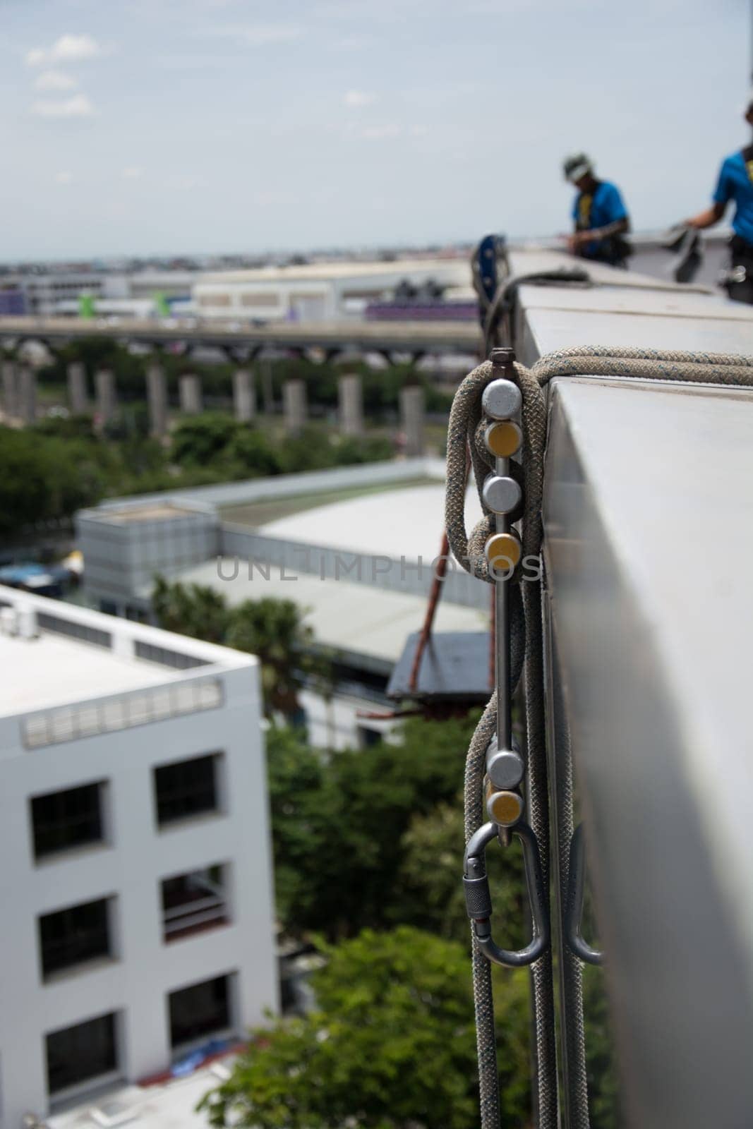 workers cleaning windows service on high rise building