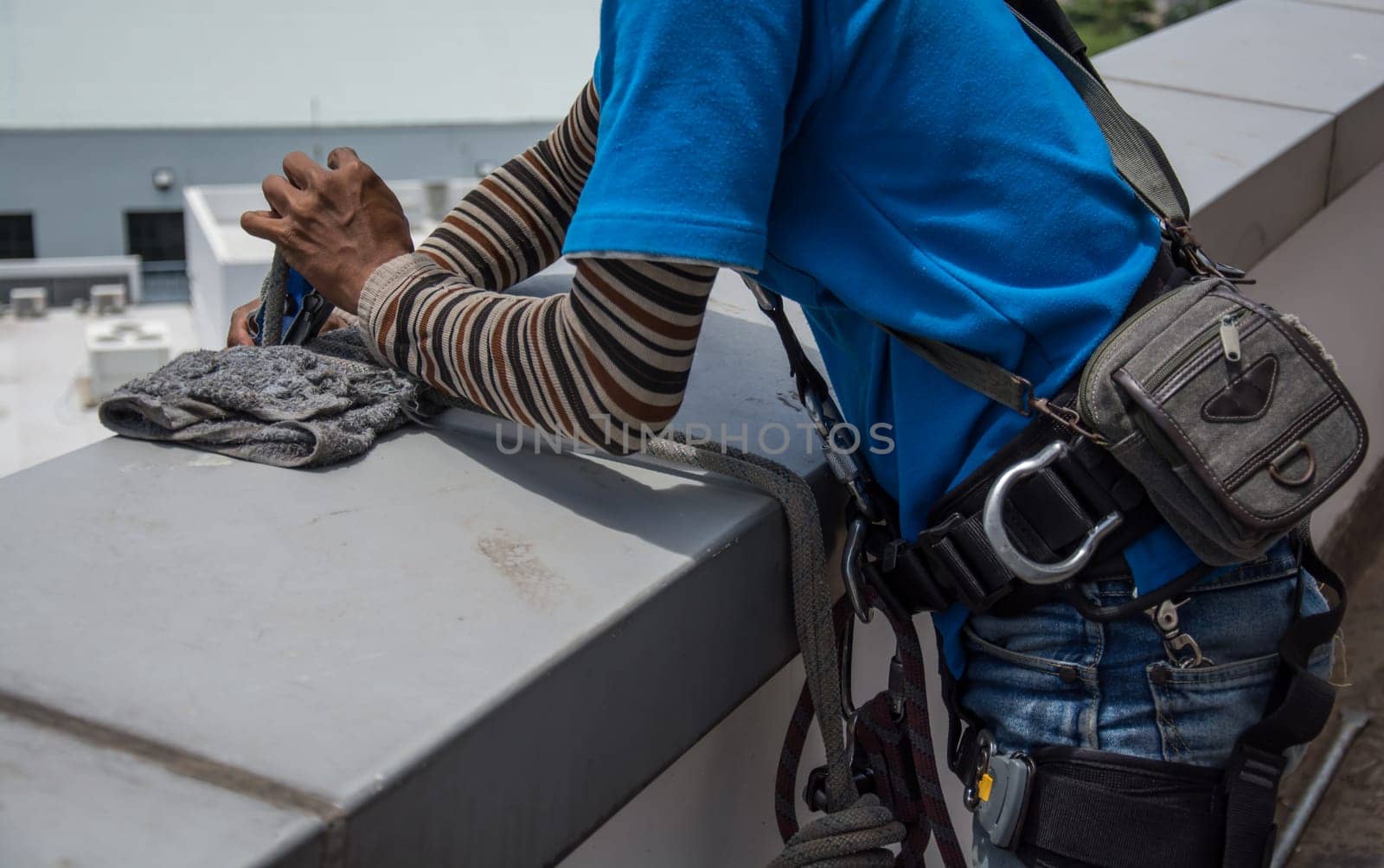 workers cleaning windows service on high rise building