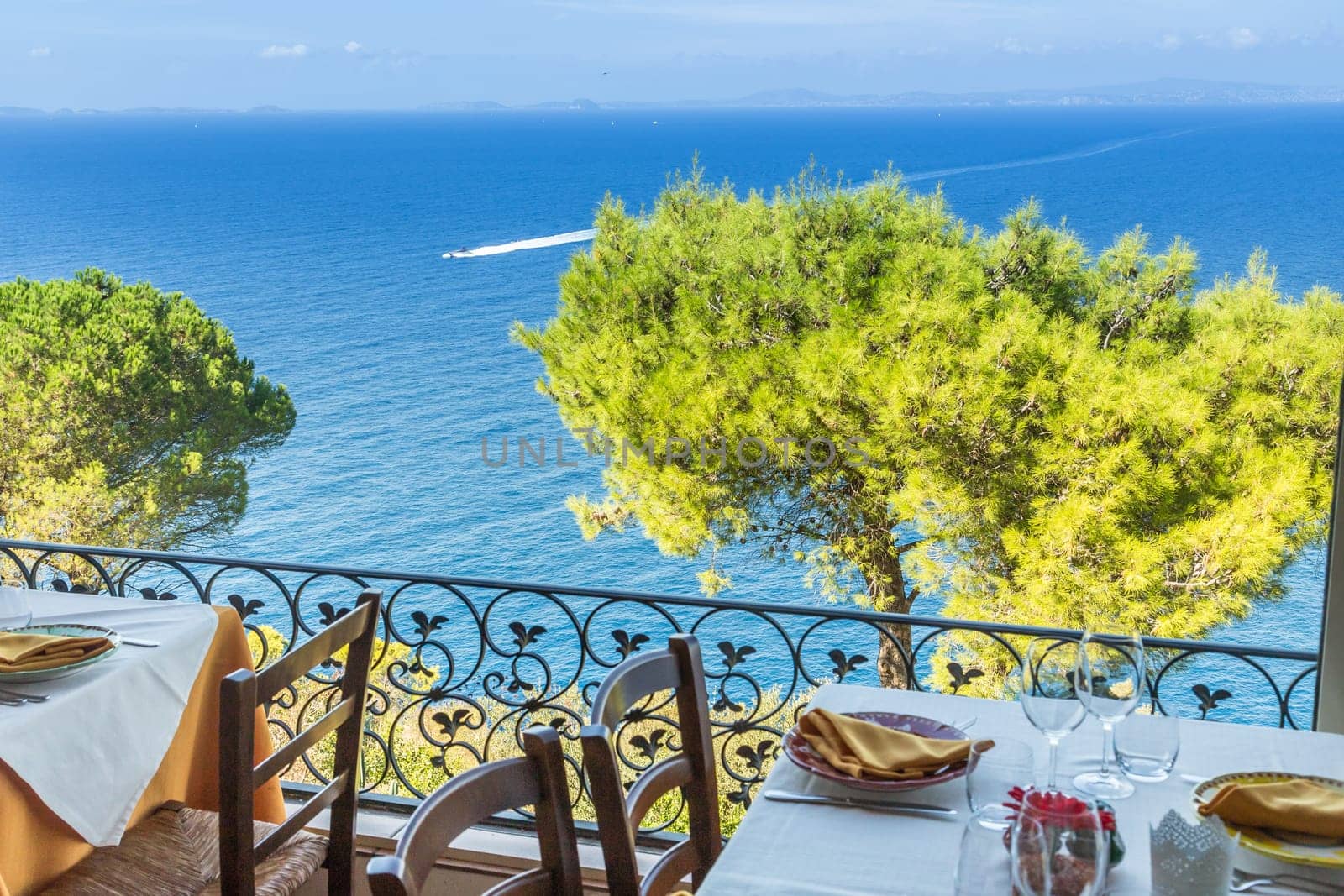 Restaurant table overlooking the sea on the Amalfi coast in Italy.