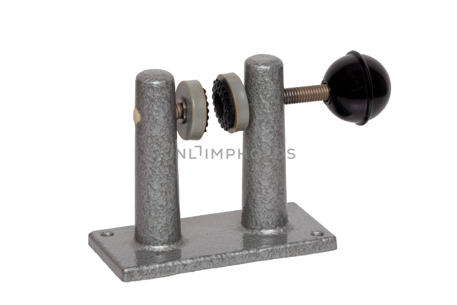Close-up of an old clamp device that was used to frame film strips between two glasses. Entertainment last century to look holiday pictures on a projection screen. Macro isolated on white.