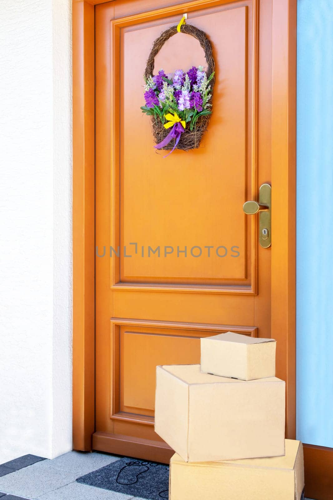 Coronavirus quarantine concept. Contactless delivery service of three packages placed at the door of house during pandemic. Stay at home and avoiding social contact and distance.