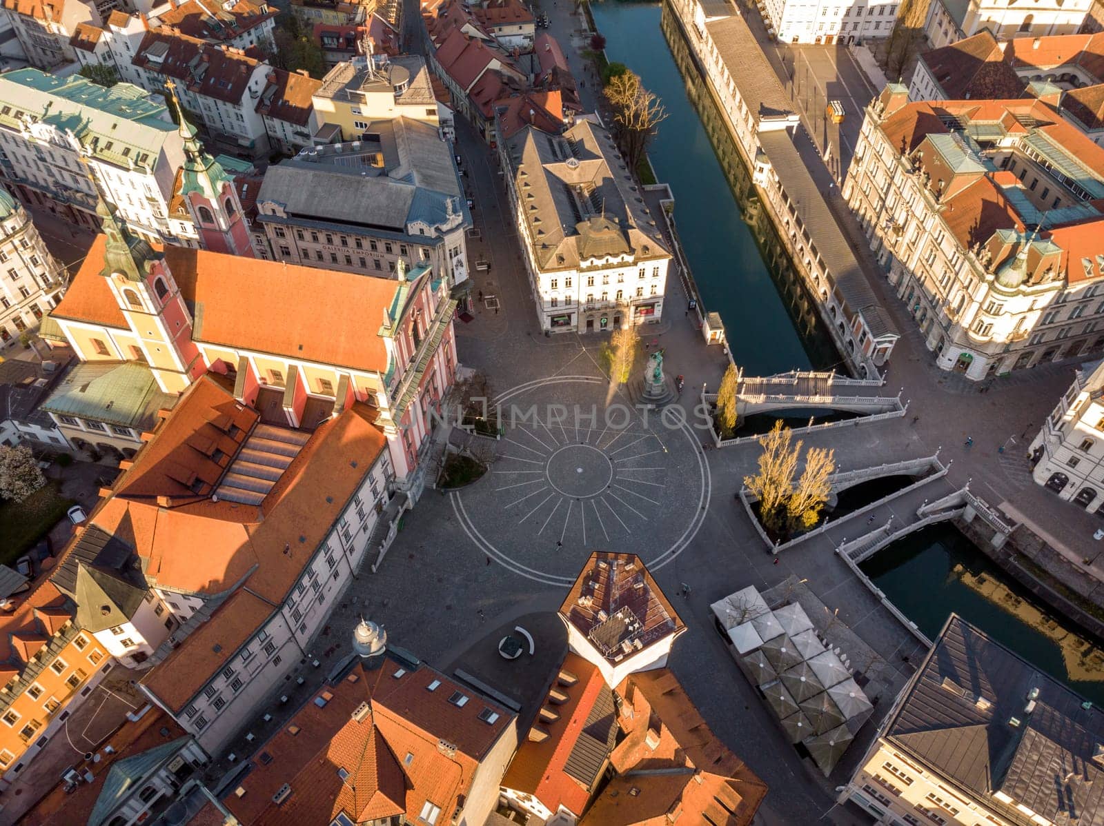 Aerial drone view of Preseren Squere and Triple Bridge over Ljubljanica river,Tromostovje, Ljubljana, Slovenia. Empty streets during corona virus pandemic social distancing measures.