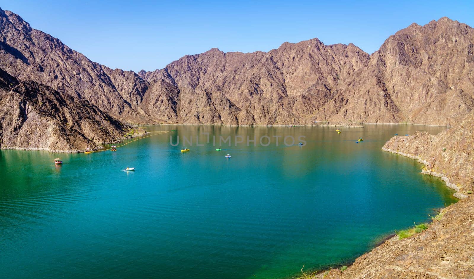 Scenic view of Hatta Lake and Hajar Mountains in the Emirate of Dubai, UAE
