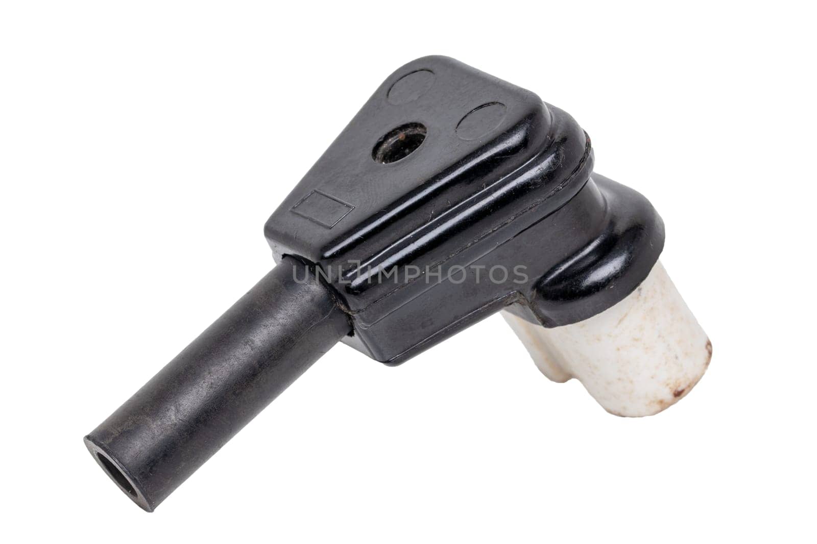 Vintage electric plug. Close-up of old rusty used electric black power plug isolated on a white background. Macro photograph.