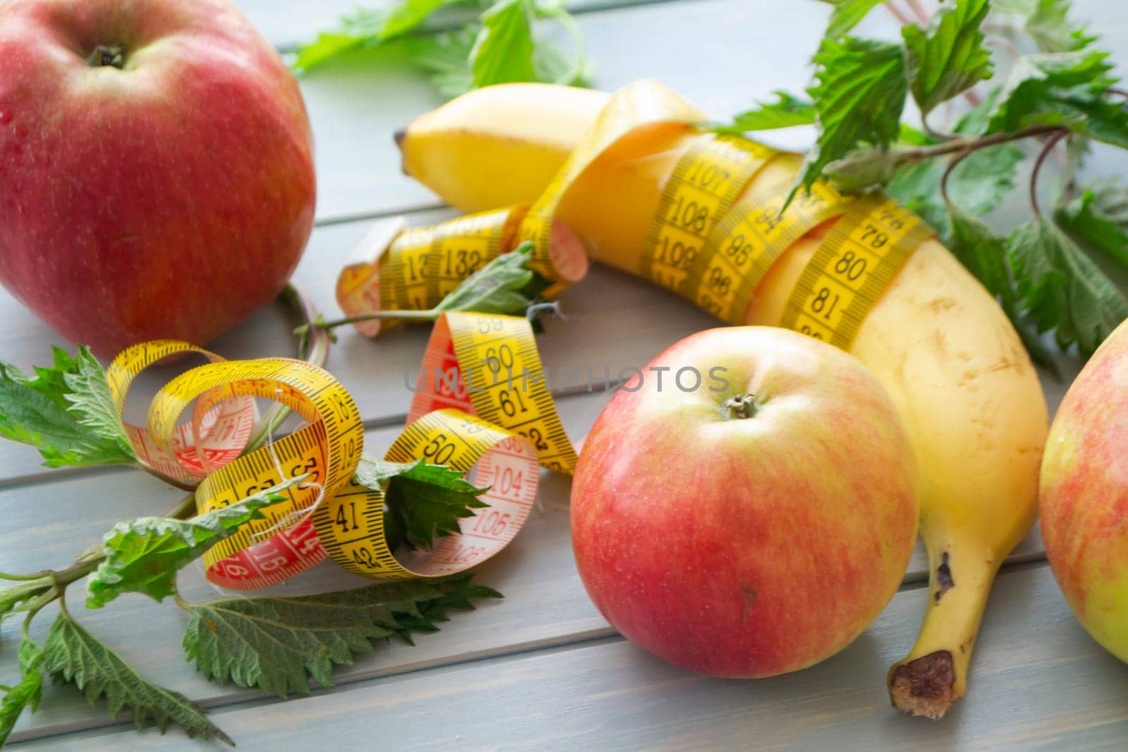 The dessert of fruit, green fresh nettle and centimeter close up on the wooden table
