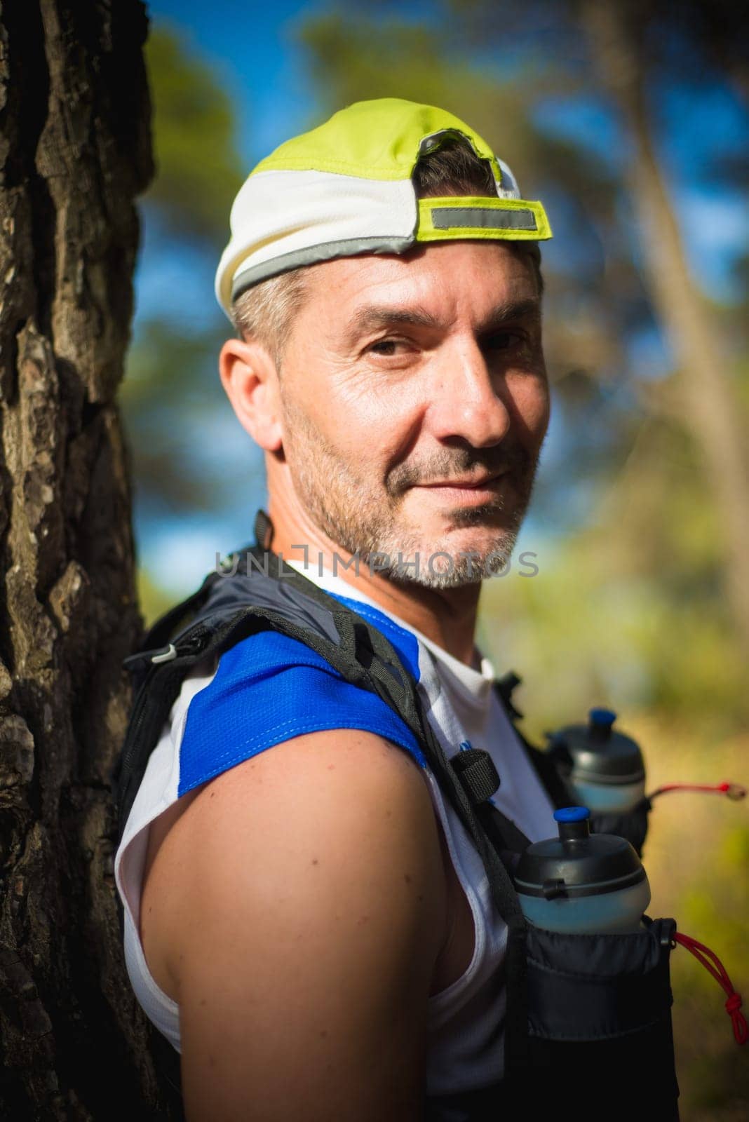 Photography session of trail runner runnig in the middle of nature and in the mountains. Preparing and interviewing
