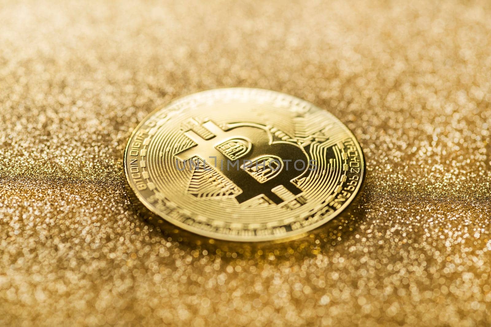 Bitcoin gold coin on a gold shining background..