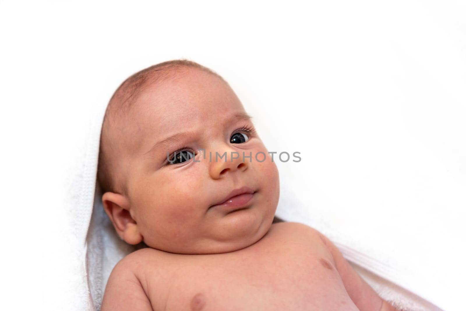 Adorable 2 months old little baby boy on towel after bath over white background