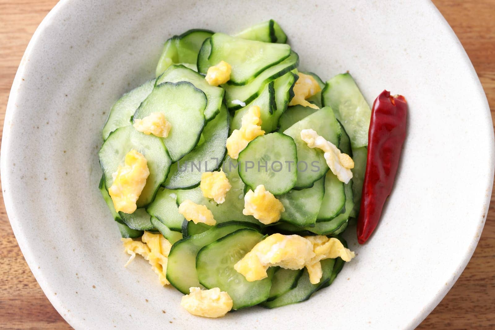 Japanese sunomono food, vinegared cucumber with baked egg in a dish