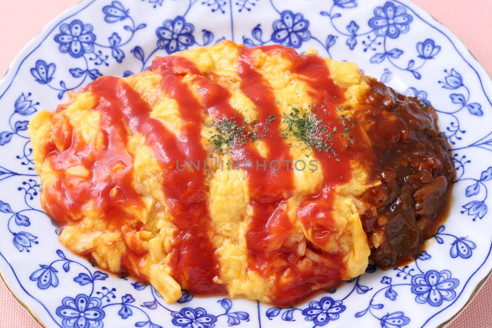 Japanese food, Omuraisu with ketchup in a plate on table