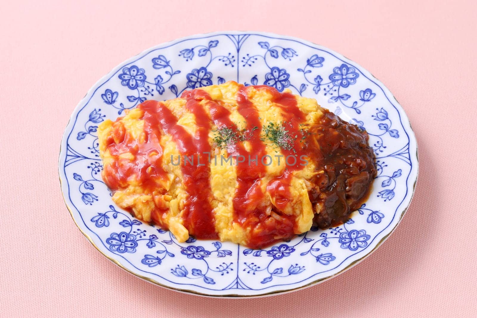 Japanese food, Omuraisu with ketchup in a plate on table
