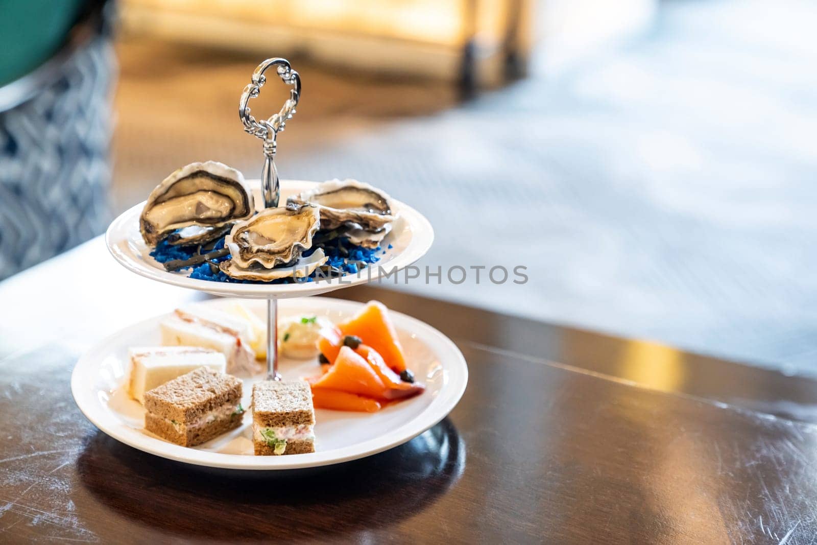 Welcome cocktail Canapes dish, Fresh Oyster and smoked salmon seafood dish. Appetizer dish before groumet brunch buffet international cuisine.