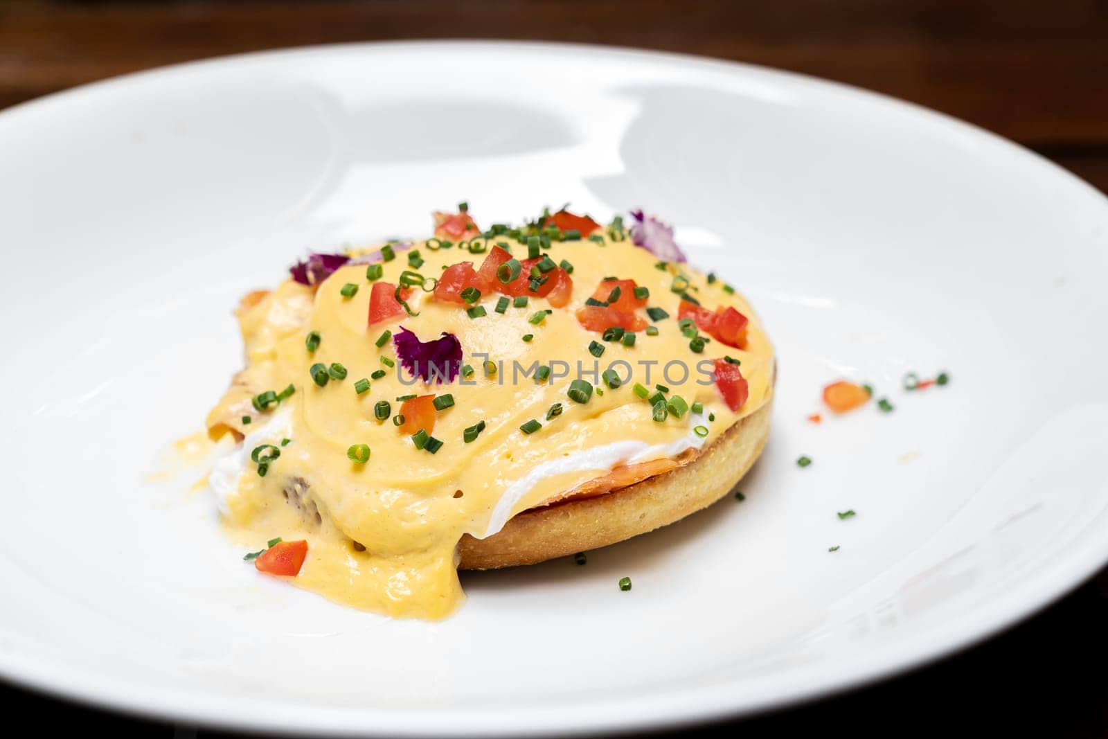 Egg benedict, Poached Egg Royal with Smoked Salmon and Tomato Hollandaise, international gourmet cuisine traditional breakfast of New York. Restaurant gastronomy food and drink consumerism concept.