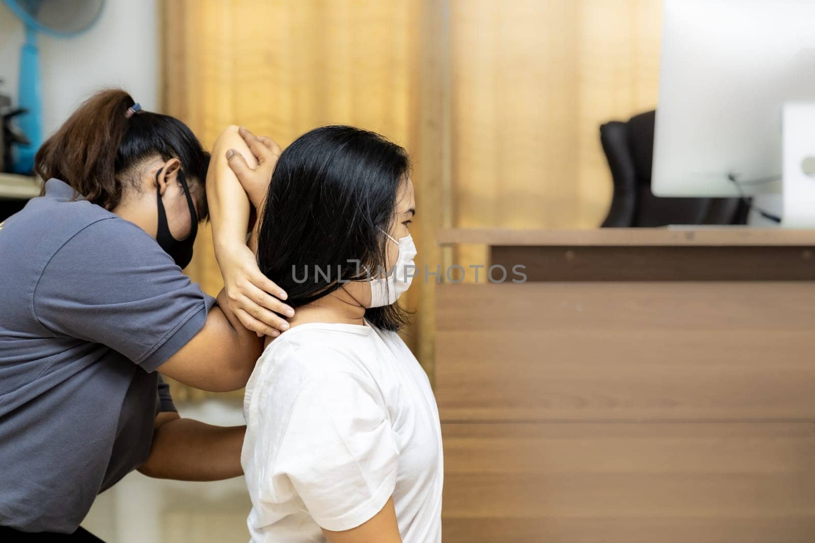 Quarantine asian woman do massage at home while city lockdown for social distance due to coronavirus pandemic. Massage and spa is one of service business that shutdown while city lockdown.